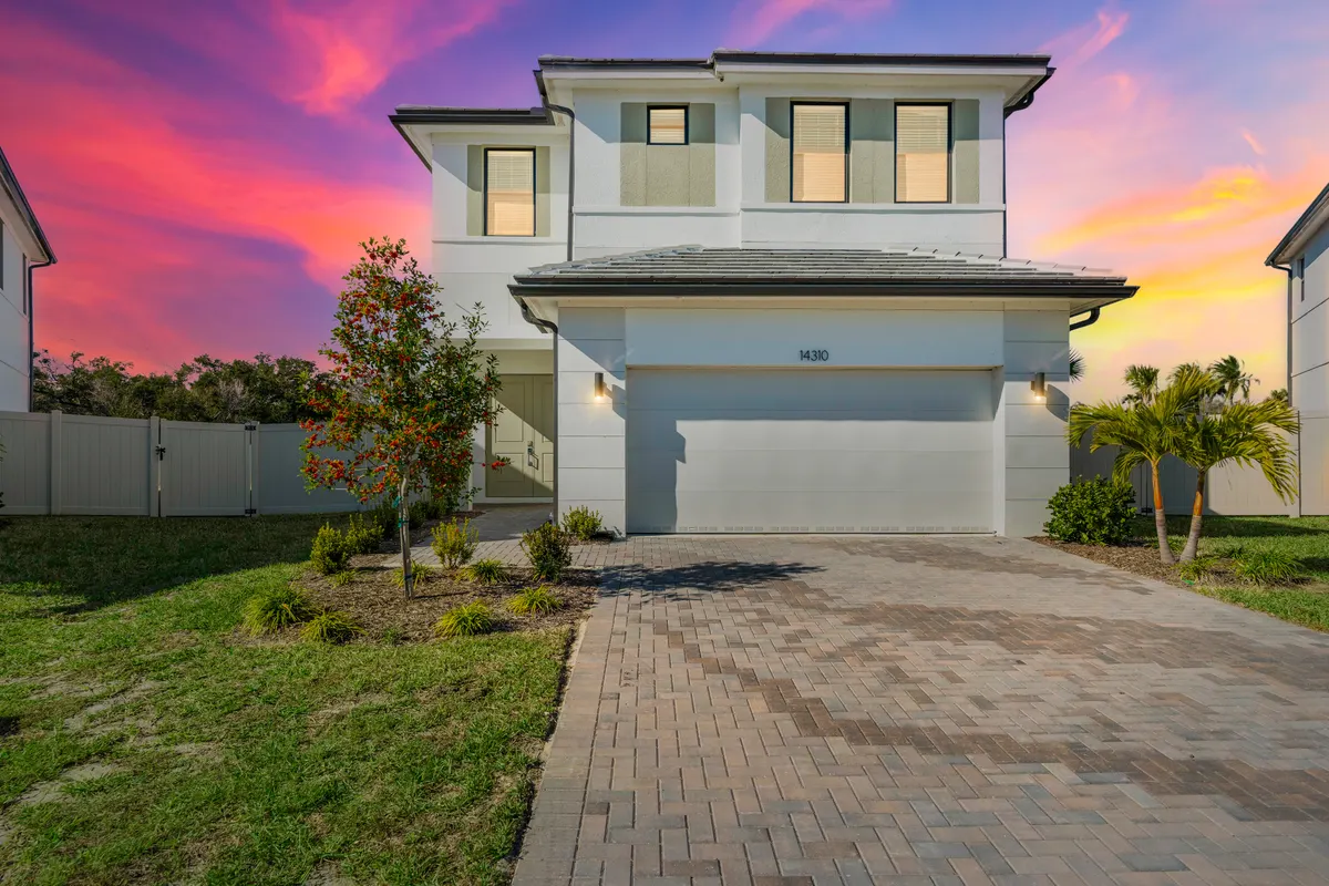Two-story single-family home at dusk with a two-car garage