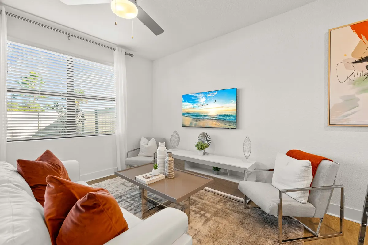 Furnished living room with a sectional and wall-mounted television